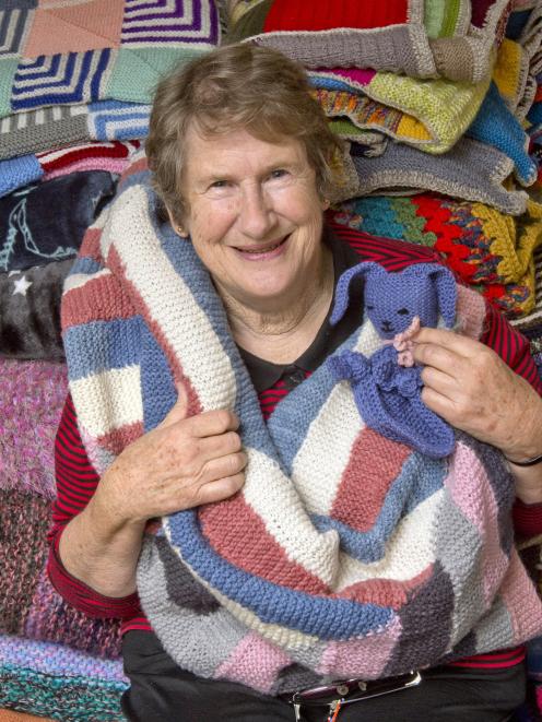 Operation CoverUp Dunedin and Mosgiel co-ordinator Suzanne Lane with some of the knitted blankets...