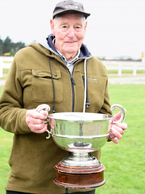 Trainer Leonard Stewart poses with the Waimate Cup after stable runner Vague won the feature race...