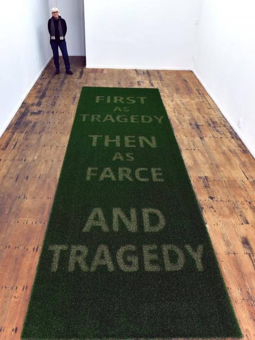 Deborah Rundle contemplates the work it took to carve words in the AstroTurf for her work Then As...