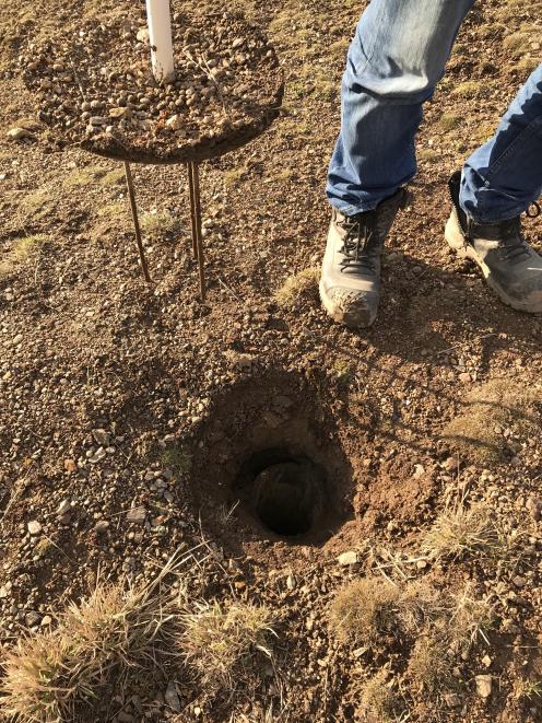 Santana Minerals project manager Kim Bunting lifts the lid on a drilling hole on Bendigo Station.