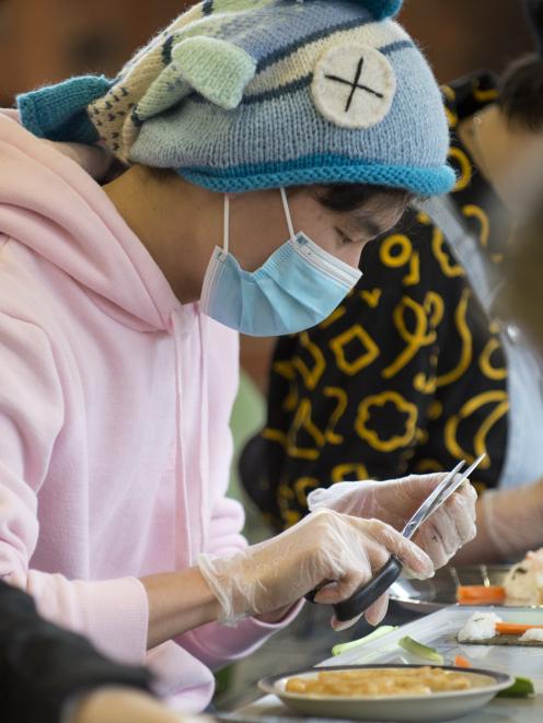 Vincent Lu carefully crafts sushi in the shape of a tree.