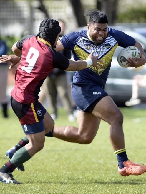 Otago centre Sione Fa’aoso tries to elude the tackle of Southland hooker Anisoni Kaufononga at...