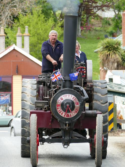 Geoff and Beth Henderson, of Pukerau, steam into town on their 1910 Burrell tractor. 