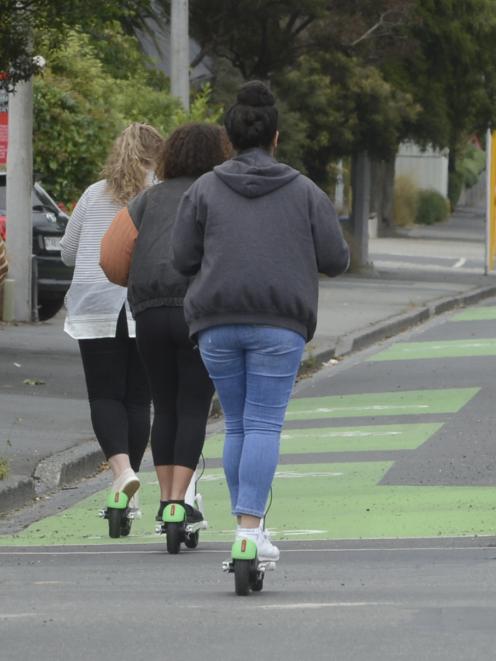 A small group of Lime scooter riders make their way down the Cumberland St cycleway. Photo:...