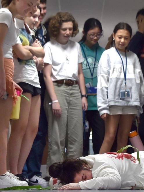University of Otago genetics PhD student Jonika Edgecombe plays dead for a genetics course during...
