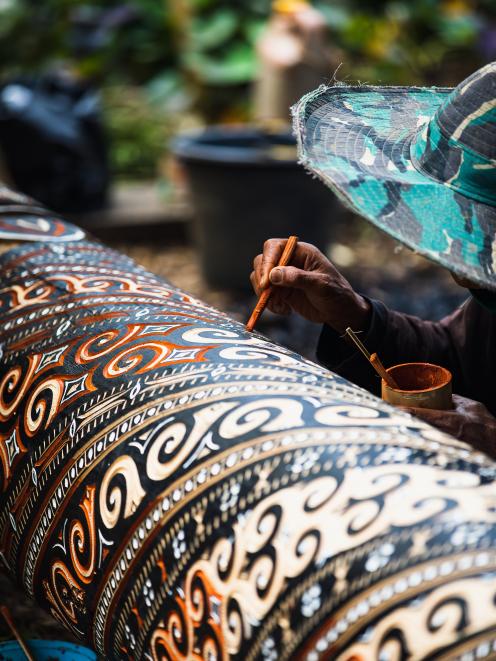 Every pillar of a tongkonan is hand-painted, a highly detailed skill passed through generations...