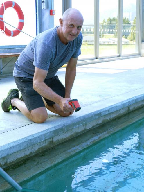 West Otago Swimming Pool committee president Barry Frew tests the temperature of the Tapanui pool...