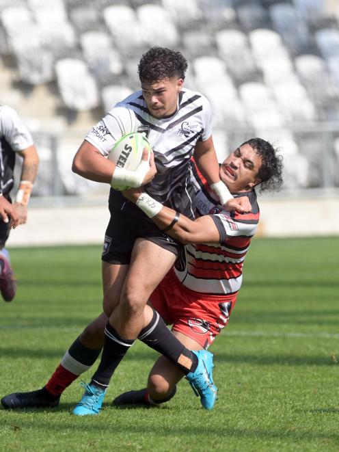 South Island Scorpions player Te Kaio Cranwell charges through the tackle of Counties-Manukau...