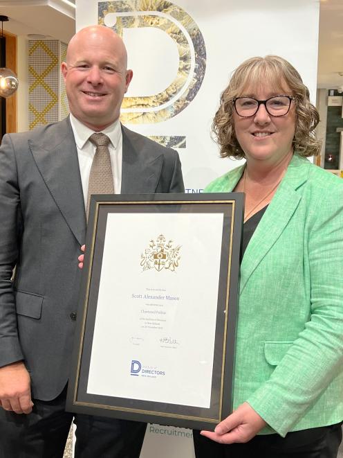 Scott Mason receives his Chartered Fellow award from Institute of Directors chief executive...