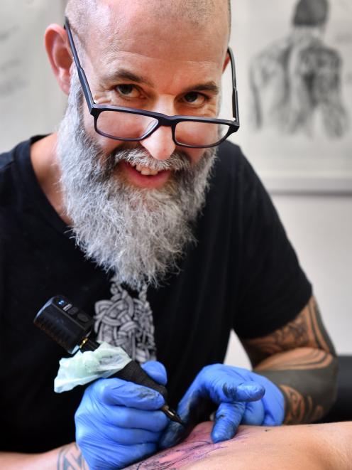 Wayne Meddings tattoos Trey Watene at Cornerstone Ink in George St, Dunedin. PHOTOS: PETER MCINTOSH