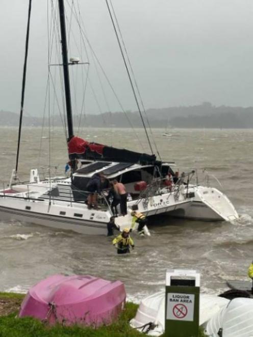 Paihia volunteer firefighters helping to rescue a large catamaran that was beached at Paihia in...