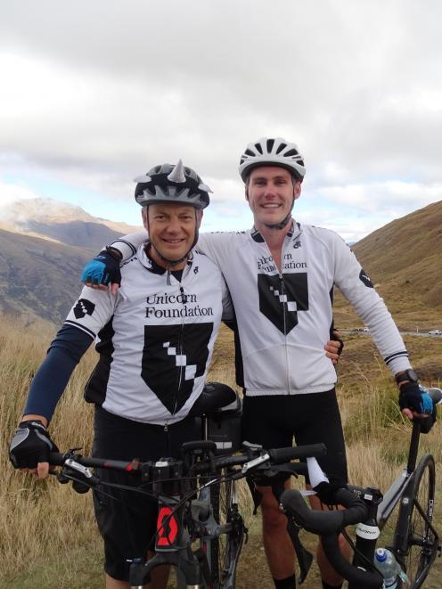 Father and son Malcolm and Harry Legget stand atop the Crown Range, having just completed the...