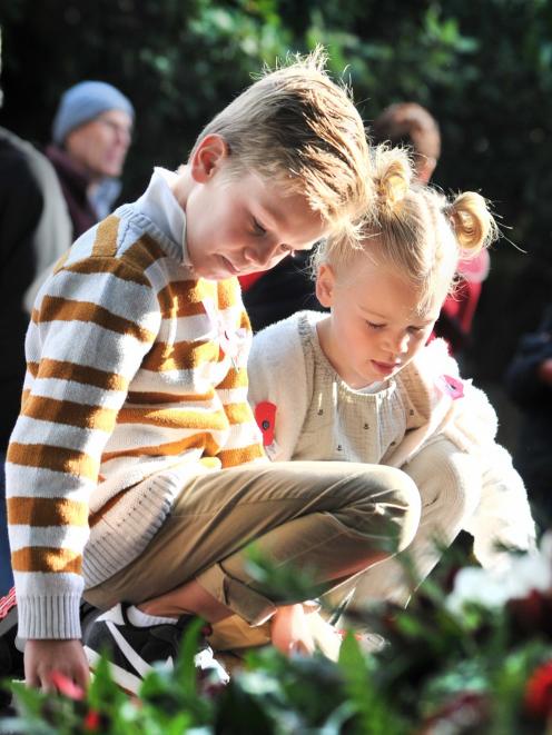 Charlie (7) and Harper (5) Sim lay their poppies on the Mosgiel war memorial at Anzac Park...