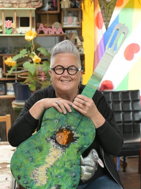 Dunedin community artist Janet de Wagt with one of the guitars Lets go to the hop featuring in...