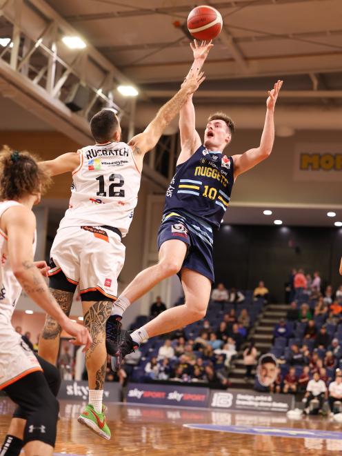 Nuggets guard Michael Harris goes up against Hawks defender Ethan Rusbatch during their National...