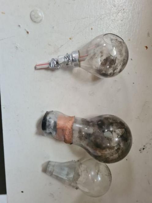 Photographs taken by landlords show lightbulbs repurposed as meth pipes. Photo: Supplied