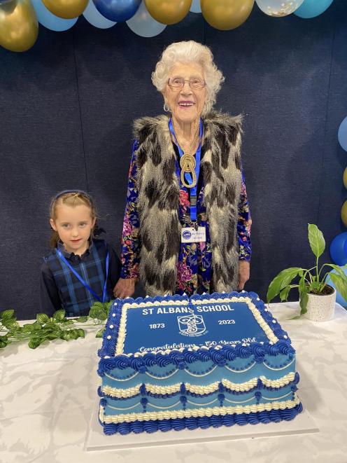 The youngest student, Frankie Woods, and the oldest ex-student, Ida Clancy, 96, cut the cake...