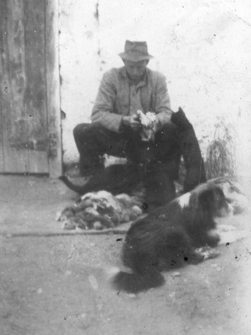 Uncle Ernie Huddleston, as a teenager, skinning rabbits.