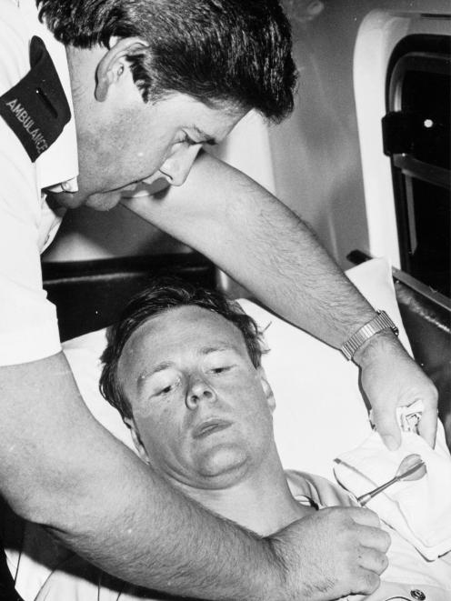Ambulance officer Brian Sproull tends to patient Constable Craig Edge after he was injured by a...