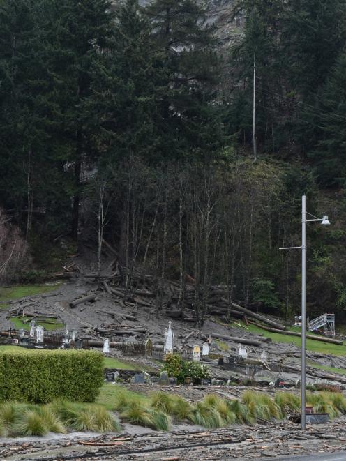 Logs flood on to the Queenstown cemetery yesterday. PHOTO: Gregor Richardson