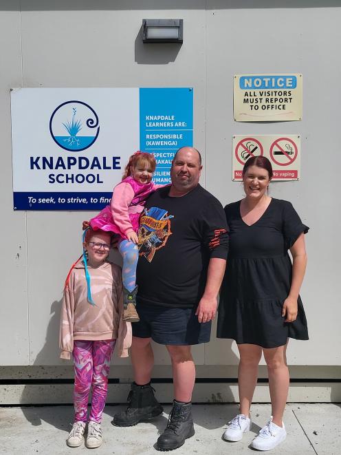 A clean-shaven Hamish Milne and daughters Paisley, 5, whom he is holding, and Emily, 8, celebrate...
