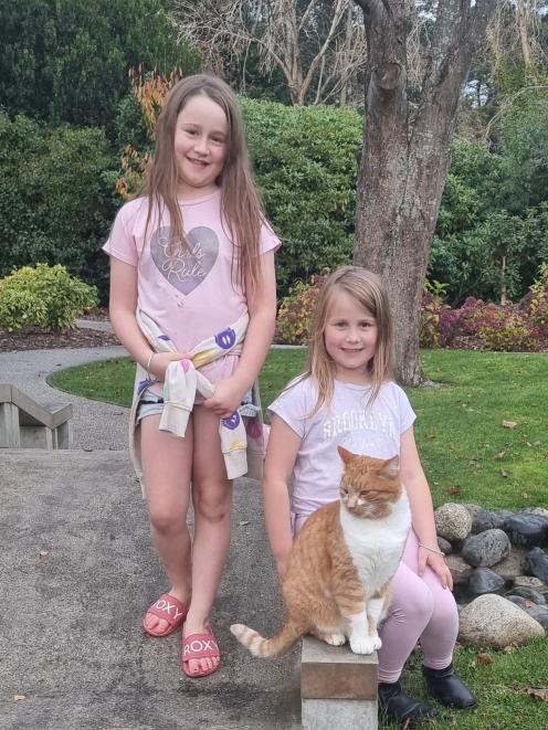 Isla Russell, 8 (left), and Evie Russell, 6, with Junior at Queens Park. PHOTO: SUPPLIED
