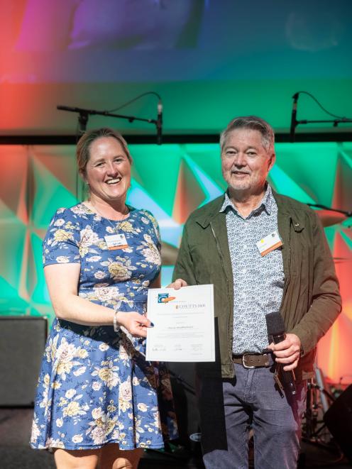 Olivia Weatherburn receives the Amabel Fulton APEN Award from Jeff Coutts during a conference in...