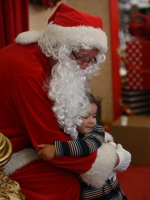 Cleo Cole hugs Santa Claus at the Meridian Mall yesterday. PHOTO: LINDA ROBERTSON