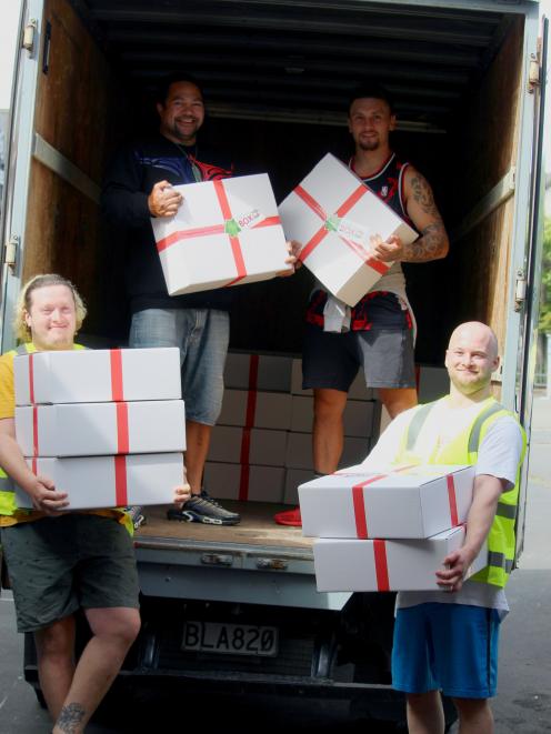 Loading food boxes for families in need are volunteers (from left) Henry Bassant, Pounamu...