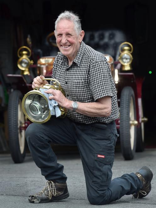Colin Winter polishes a lantern from his 1900 Wolseley (nicknamed Grandma), in preparation for...