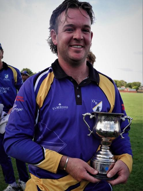 Old Boys captain Jack Lewis with the Christchurch Metro one-day trophy after last year's final....