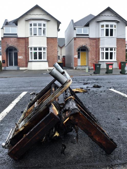 The remains of a burnt couch lie in a carpark in Castle St today. PHOTO: PETER MCINTOSH