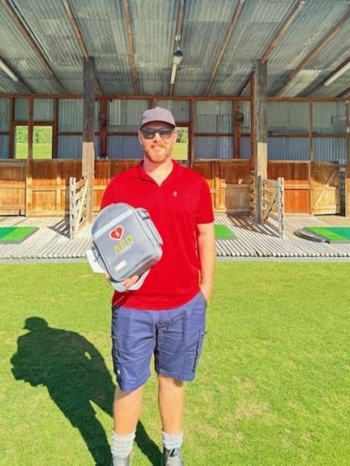 Millbrook golf course assistant superintendent Ollie Nilsson with the driving range defibrillator...