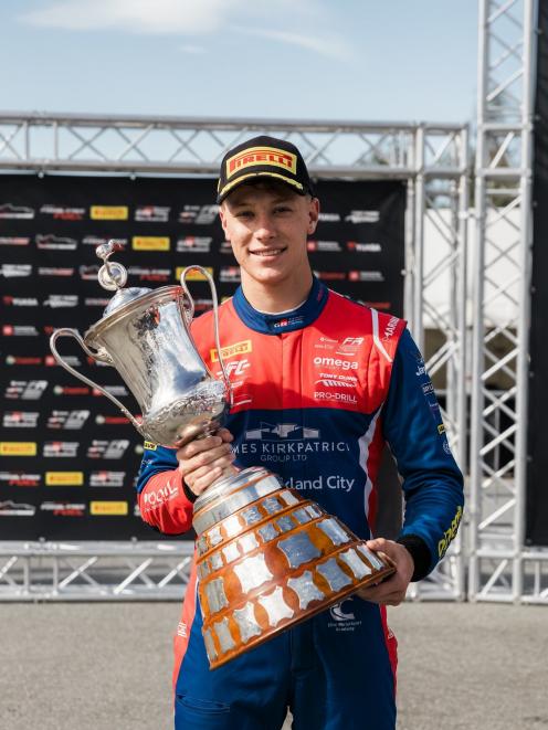 Liam Sceats holds the New Zealand Grand Prix trophy after winning the 27-lap race at Highlands...