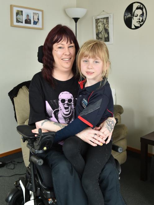 Dunedin mother Lara Elliot sits in her wheelchair with her daughter, Amelia, on her lap. PHOTO:...