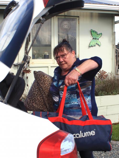 Bluecliffs resident Diane Jarvie loads her bags into the car as she prepared to evacuate her home...