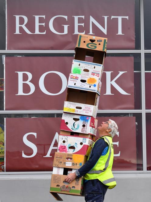 Task Force Green supervisor Andrew Maton carries away a tower of empty boxes following the most...
