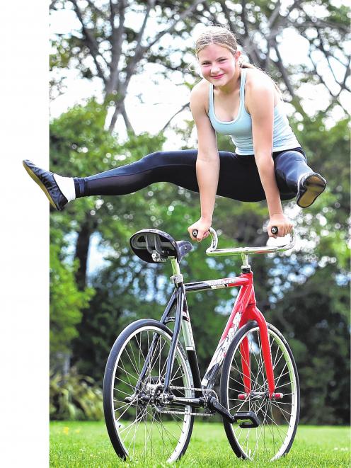 Queen's High School pupil Martha Lippross performs a trick on her special artistic cycling bike...