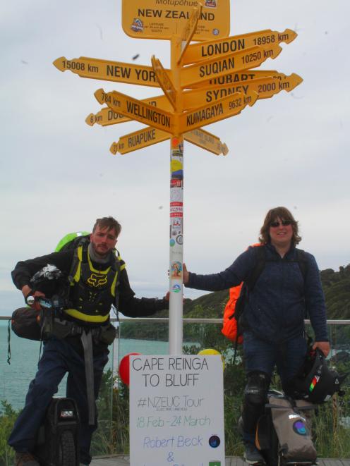 Linus Gilbert (left) and Robert Beck end their 36-day electric unicycle ride from Cape Reinga to...