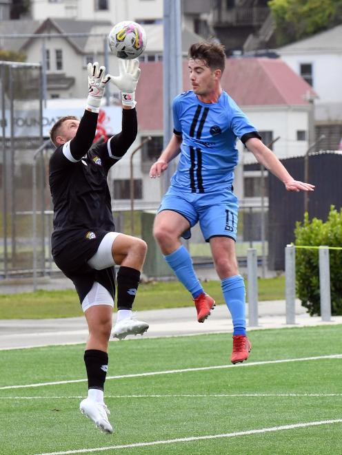 Dunedin City Royals player, Will Turner, engages in an aerial battle with Cashmere keeper Danny...