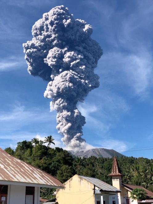 A column of ash rises over the Mount Ibu volcano, in Tabaru, North Maluku province on Monday....