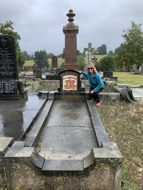 Christine Chisholm poses beside the graves of her great-grandparents Creighton Reid and Sarah...
