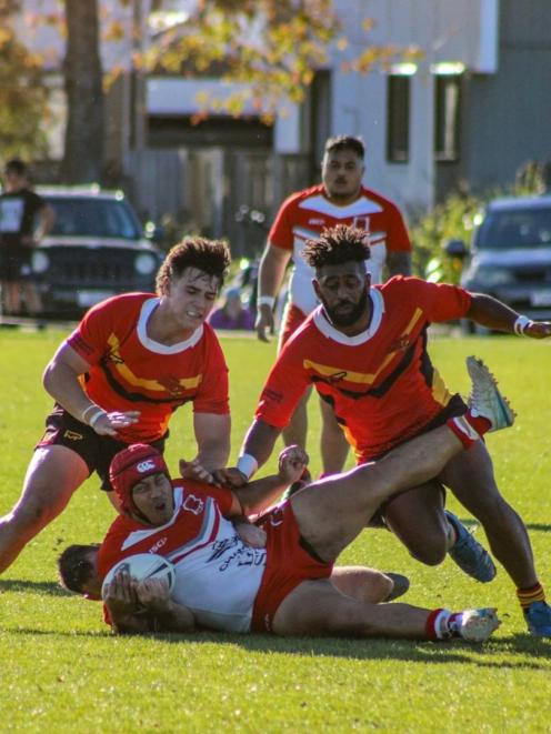 Halswell’s Cooper Te Hau and Jope Drala combine to tackle an Eastern player during Eastern’s 32...
