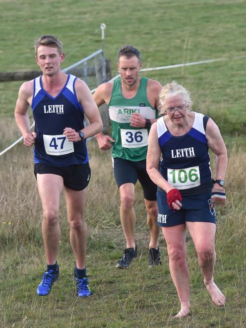 Corey Lewis (left) and Eddie Smith gain ground on a barefooted Christine Montgomery during the...