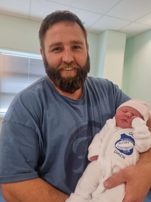 Wyndham rugby player Brad Shaw and baby Marlee fly the flag shortly after her birth at Southland...