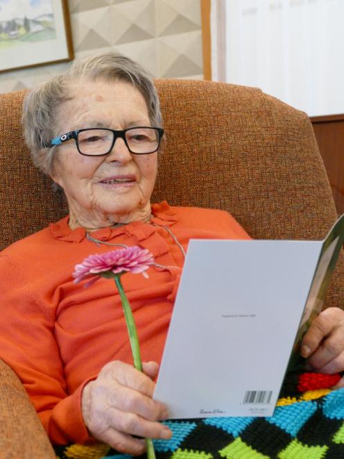 Phyllis Beeby reads one of many cards from well-wishers during her 100th birthday celebration...
