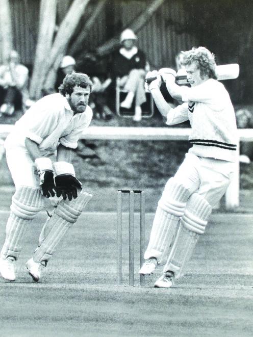 Cricketer John Reid plays a pull shot, watched by Northern Districts wicketkeeper Mike Wright, in...