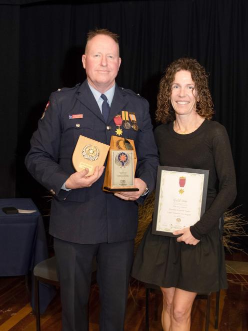 Clyde Fire Brigade Station Officer Tim Paulin and his wife Tisha after he was presented with a...