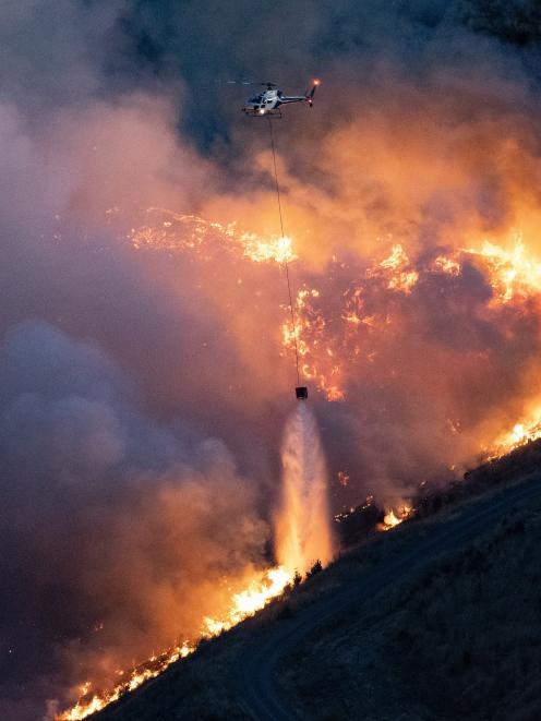 A helicopter fighting the Port Hills fire on February 14, 2024. PHOTO: GETTY IMAGES