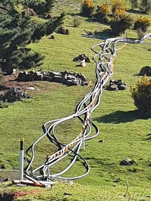 Temporary water pipelines snake across the hillside to bypass a water main breach in Maia. PHOTO:...